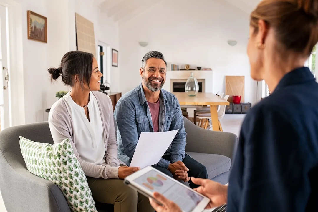 Couple talks to financial advisor about debt levels.