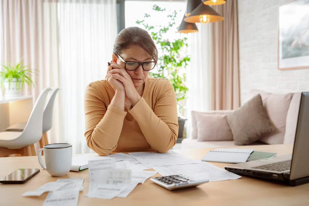 Woman contemplates bills