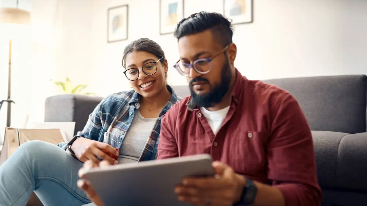 young couple using tablet to review their finances