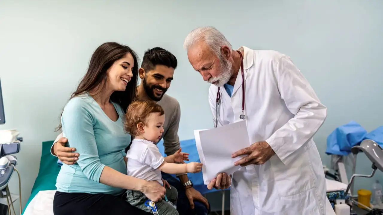 Young couple with a child at the doctor's office. 