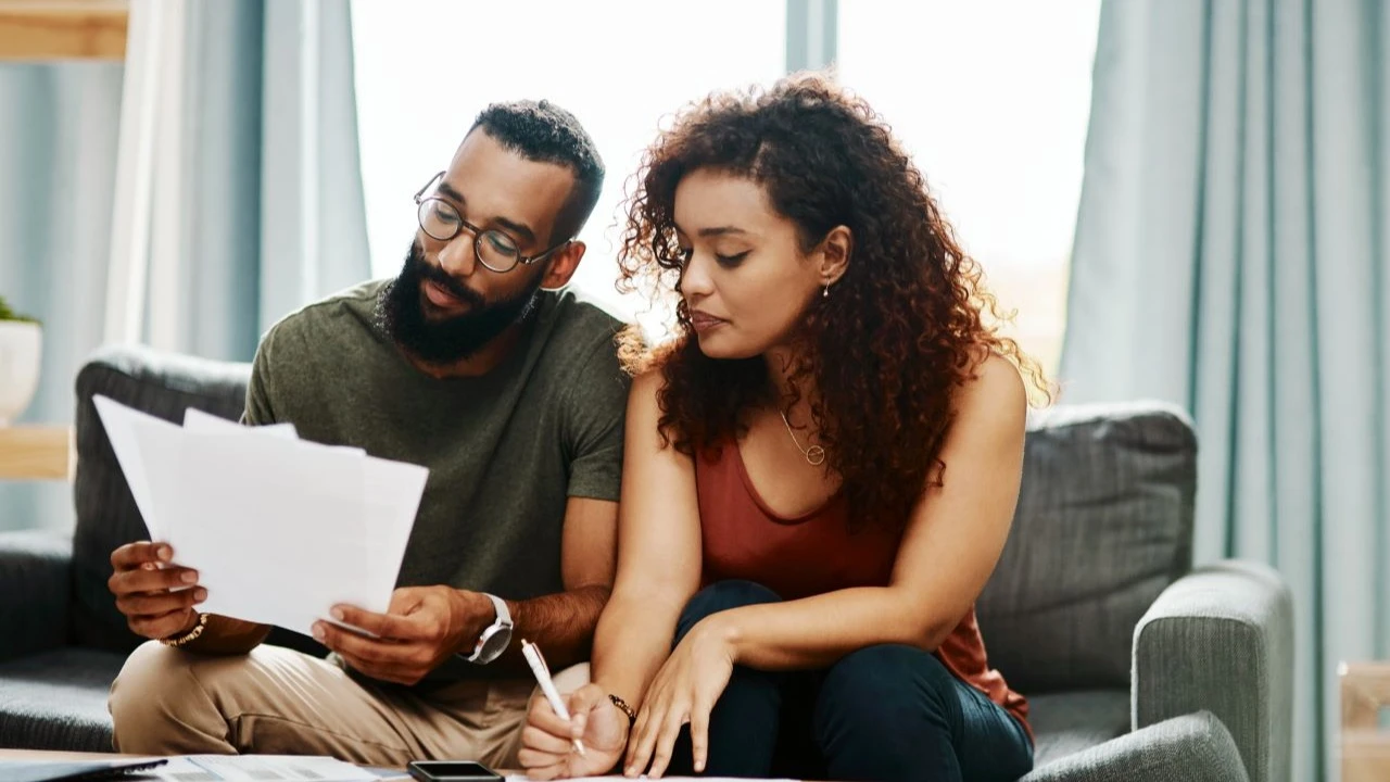 Shot of a young couple going over their finances together at home