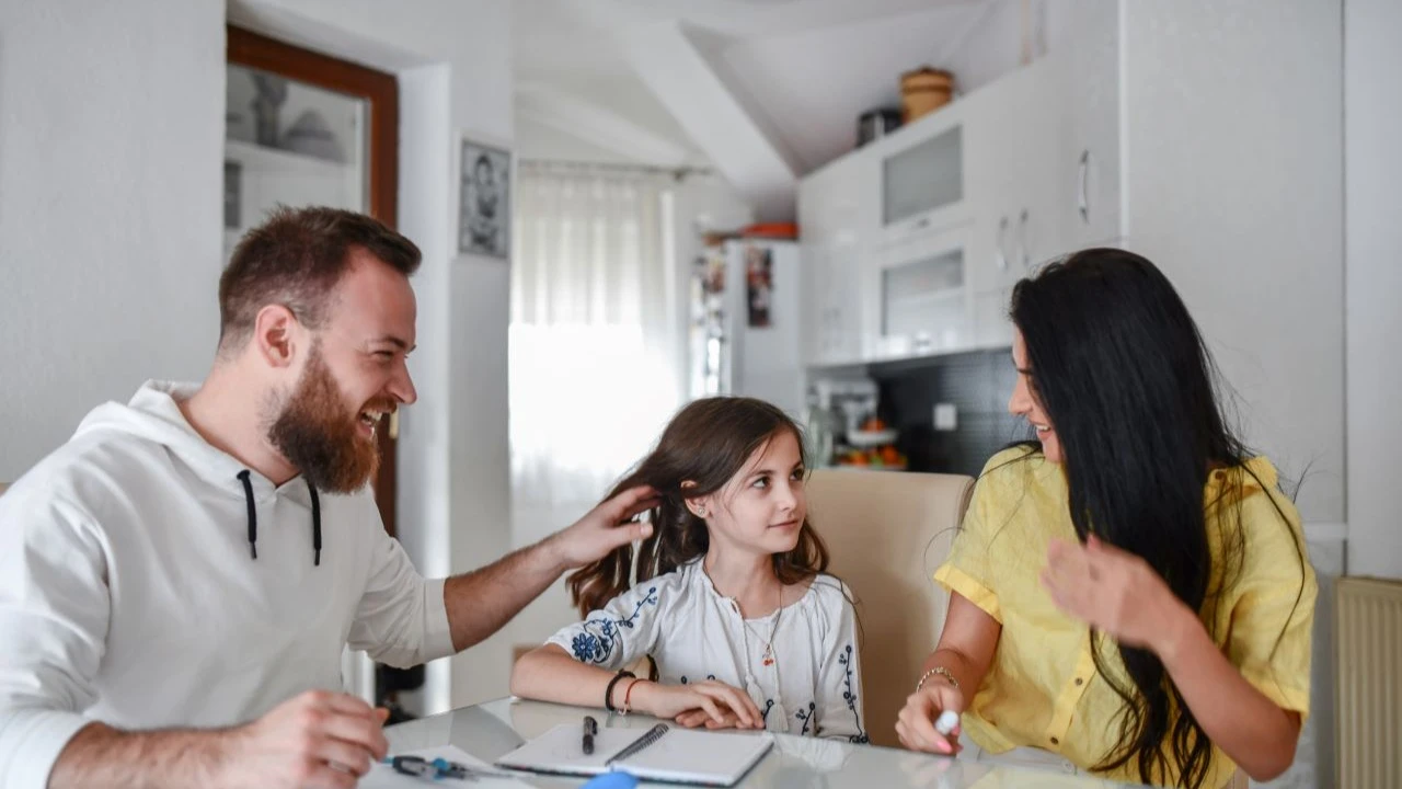 Mother And Father Enjoying Helping Child Daughter Study