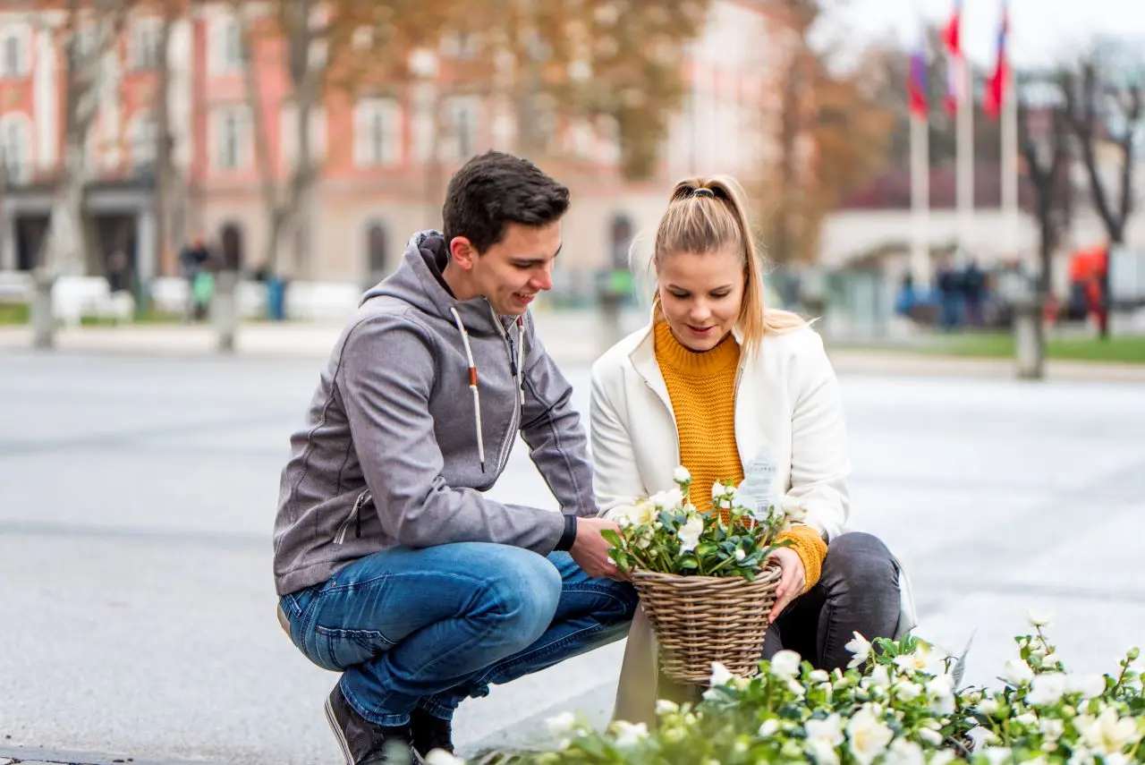 Young couple admiring flowers in the city.