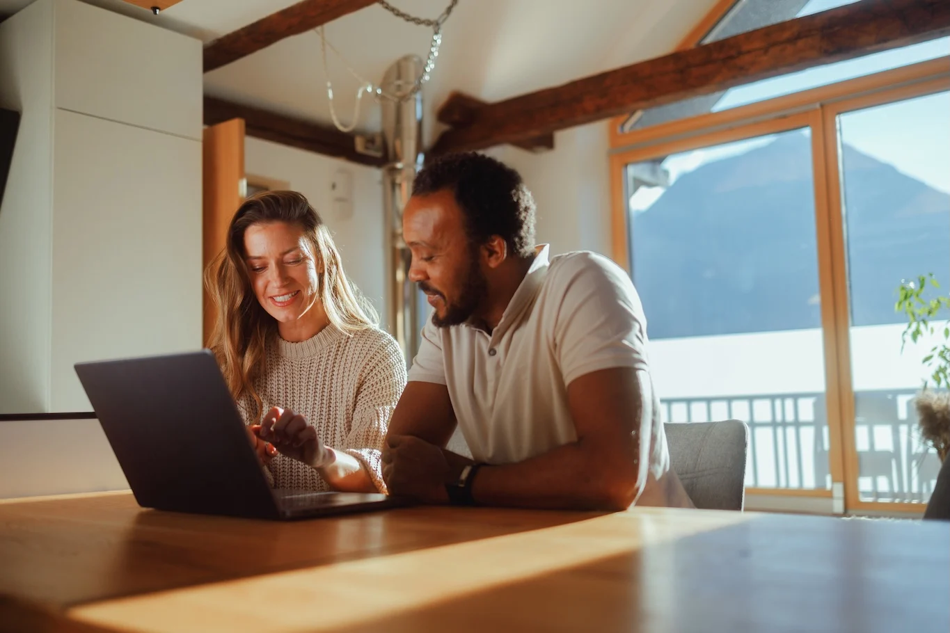Couple explores HELOC options on a laptop.