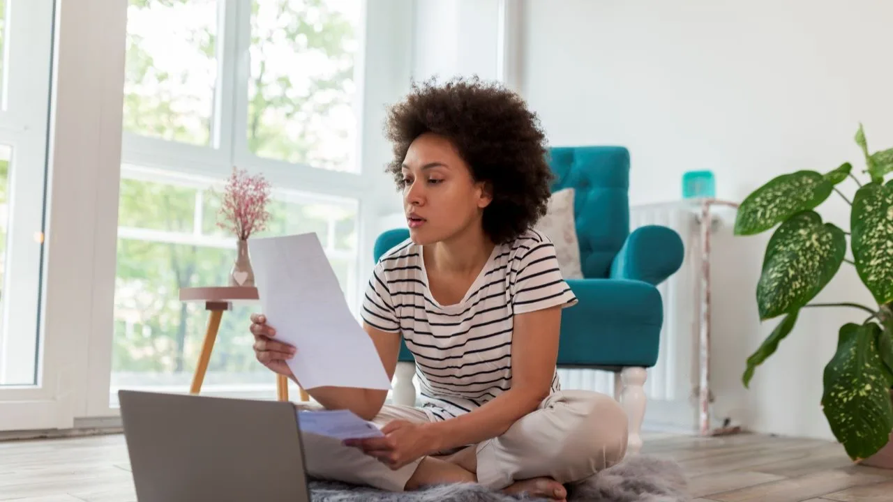 Young woman checking personal loan documents and choosing loan term