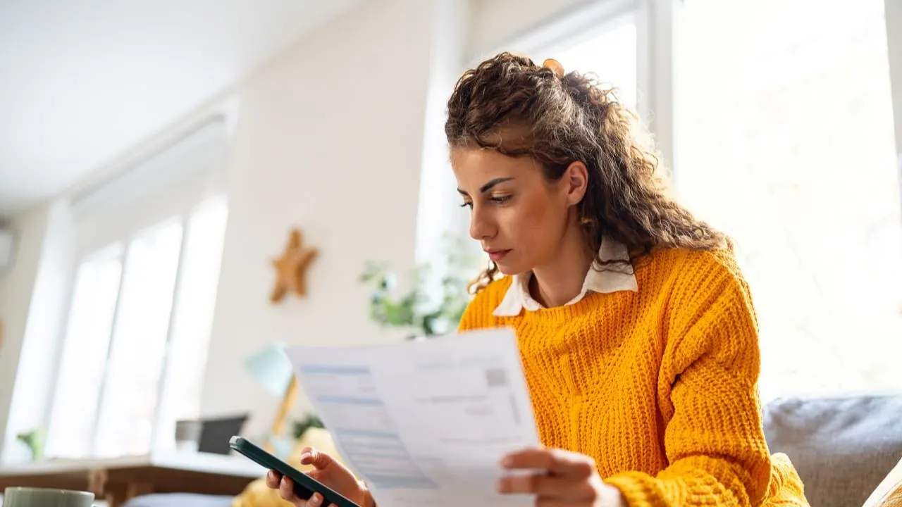 Woman reviewing finances and checking credit score after hard pull