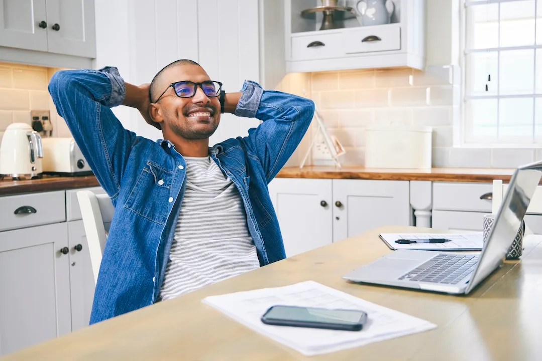 Young man relaxes at desk