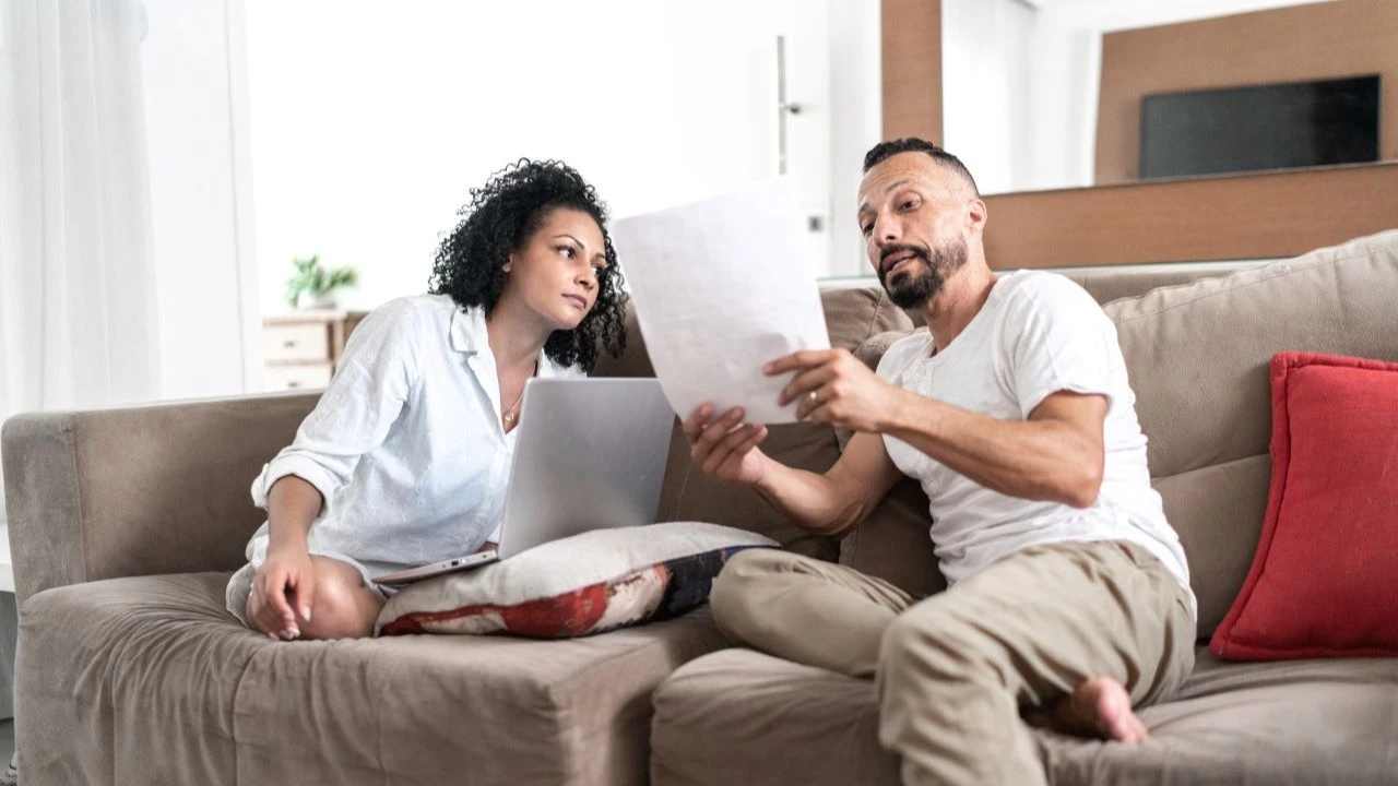 Couple at home doing home finances together