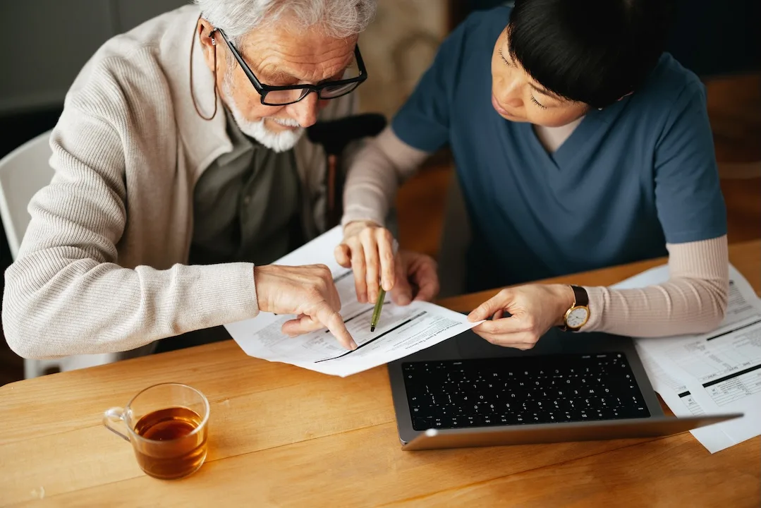 Two people review medical bills