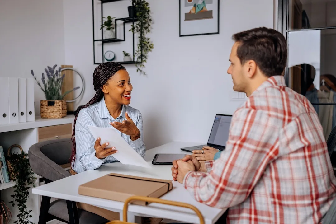 Man talks to mortgage broker. 