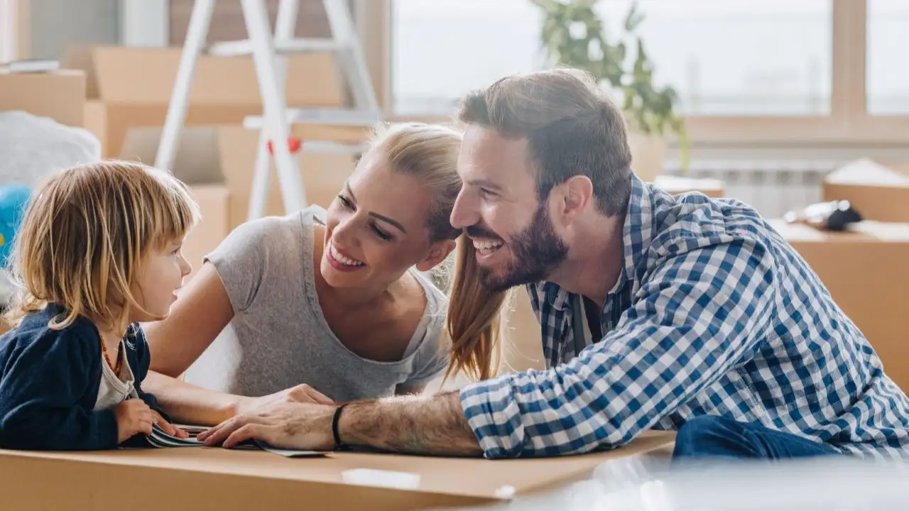 Young couple in home with child doing renovations
