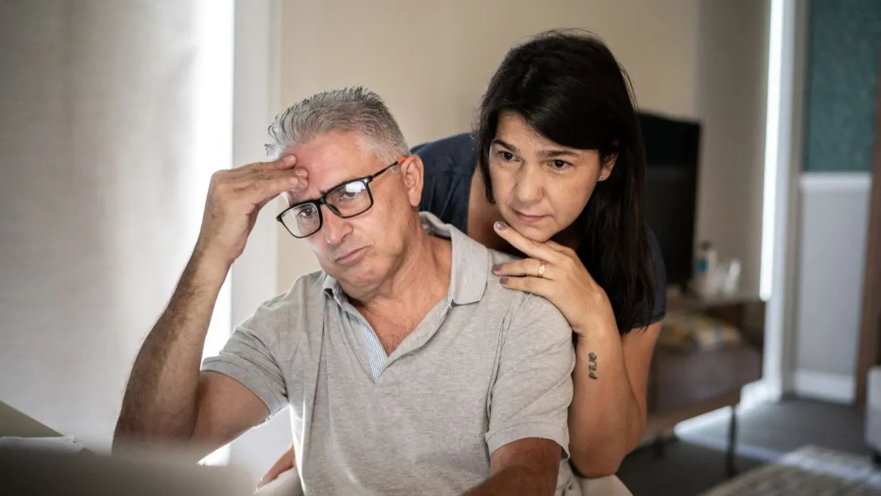 Couple contemplating financial situation and how to avoid running out of money