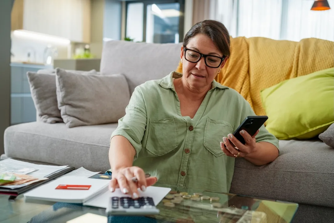 Woman does financial math with calculator