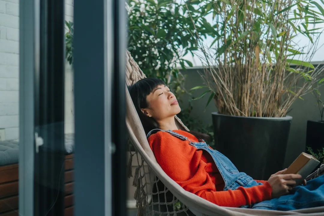 Woman relaxes in a hammock. 