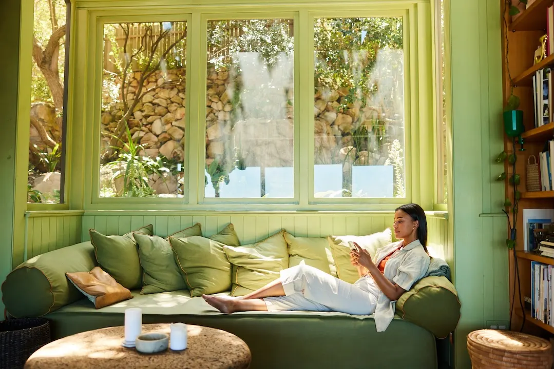 Young woman relaxing at home on her couch. 