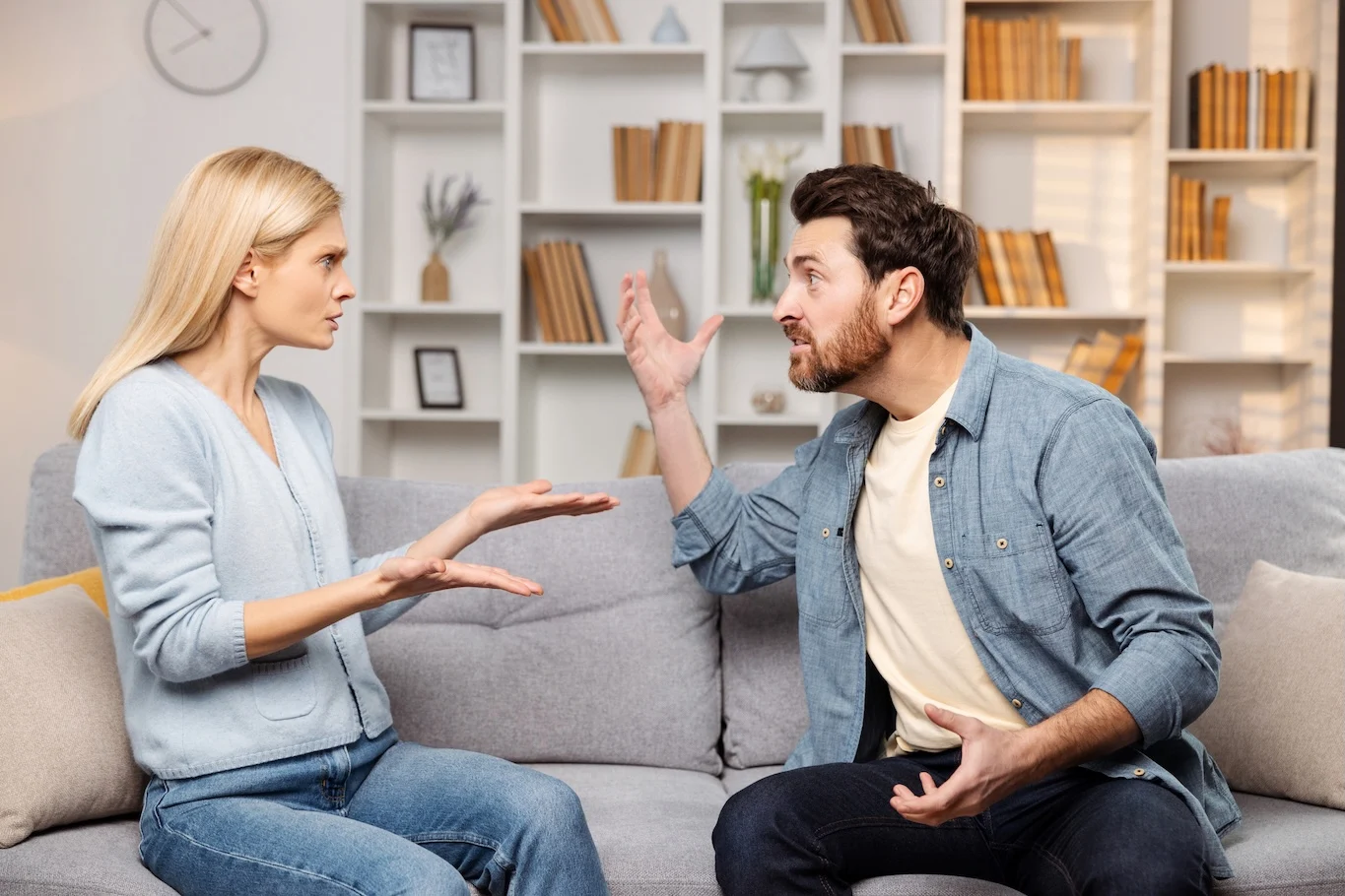 Couple arguing on a couch. 