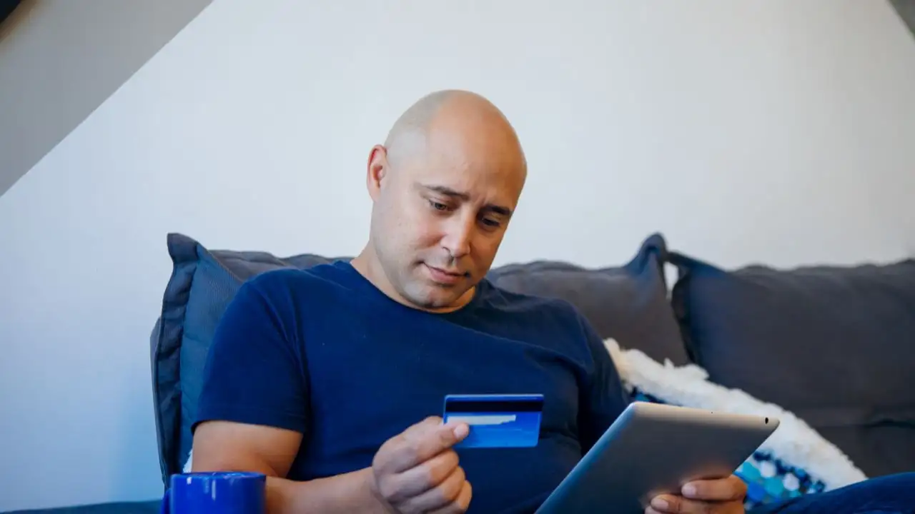 Man shopping online with his secured credit card